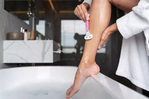 Woman shaving her legs