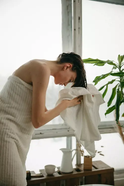 woman using towel to prepare for air drying